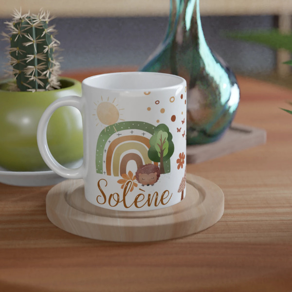Mug personnalisé tout blanc avec arc-en-ciel bohème et petit hérisson, idéal pour un cadeau nature et chaleureux.